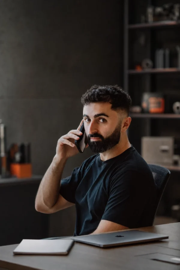 Man sitting at a desk talking to support on the phone